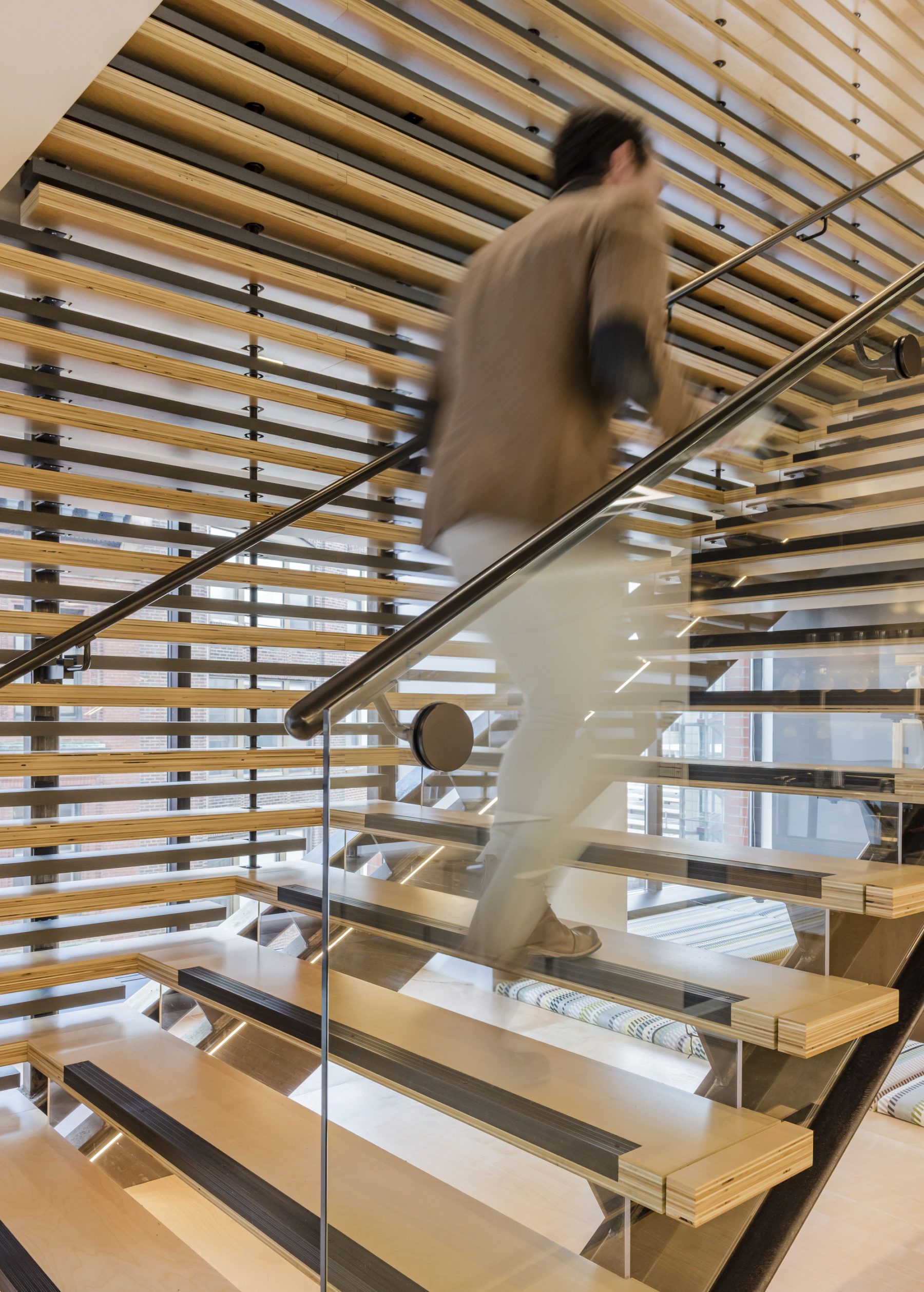 Man walks up the wooden stairs