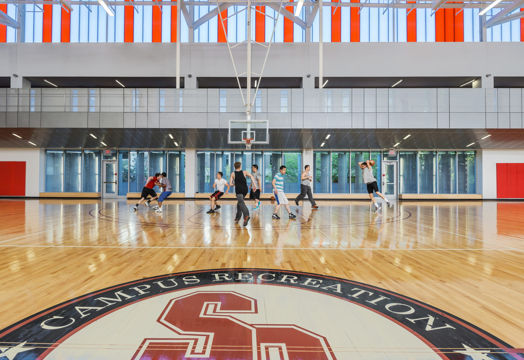 photograph of students playing basketball in indoor court