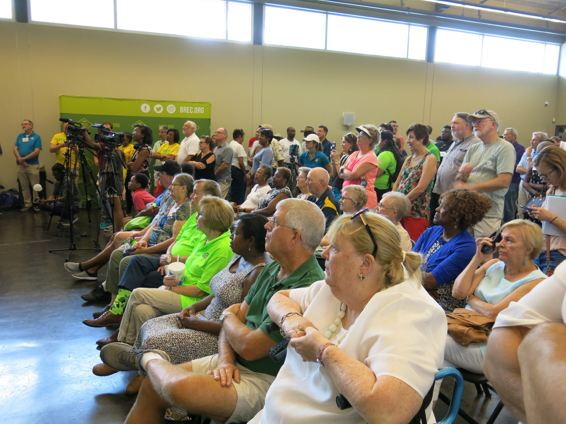 A crowd listens in an auditorium