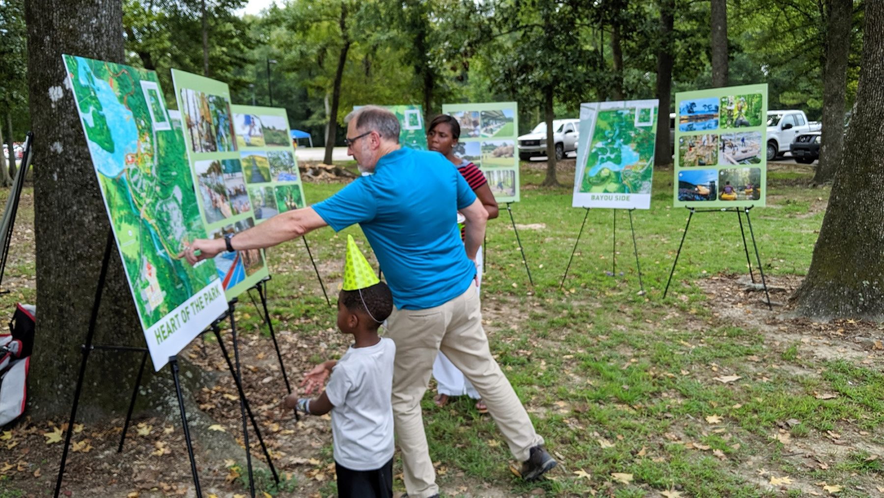 A man points to a sign in the park