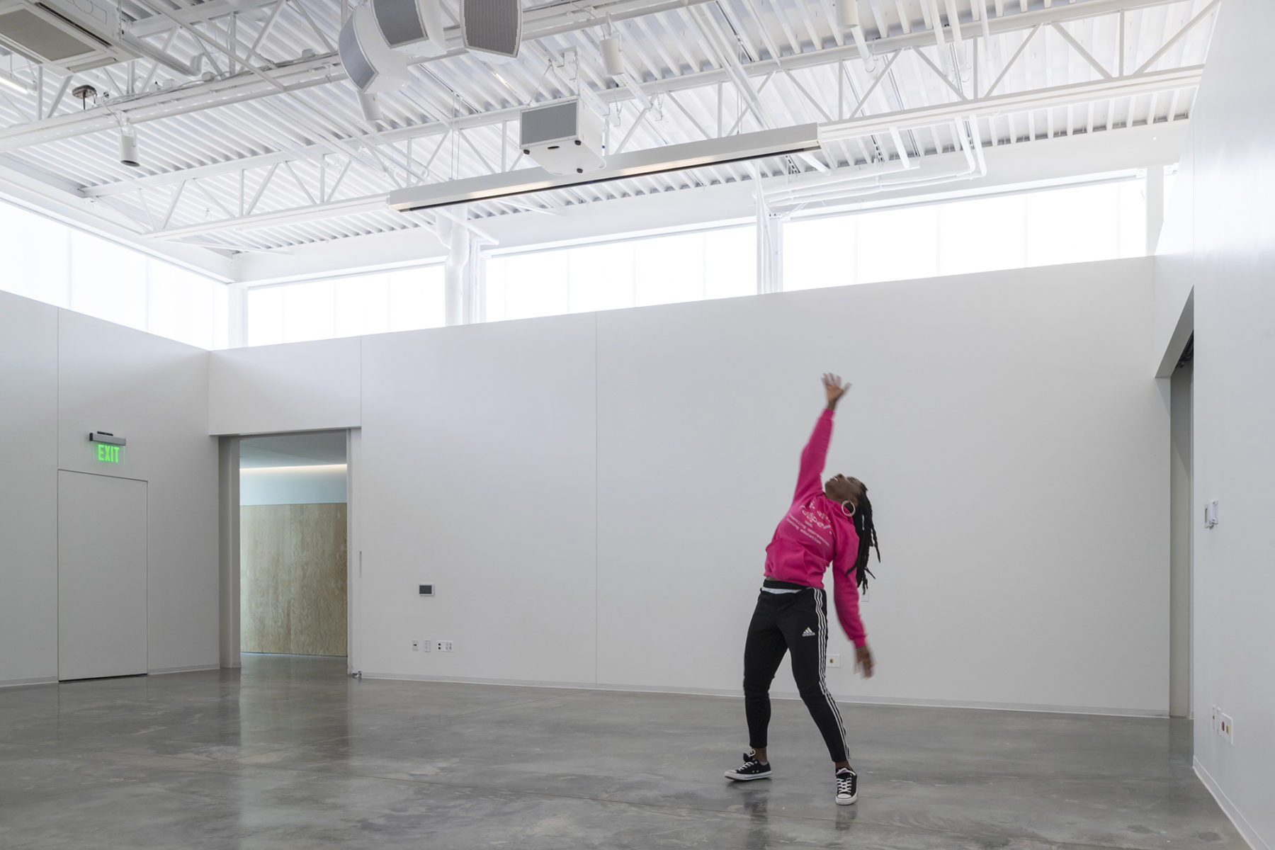 A performer showcases her talent in one of the gallery spaces