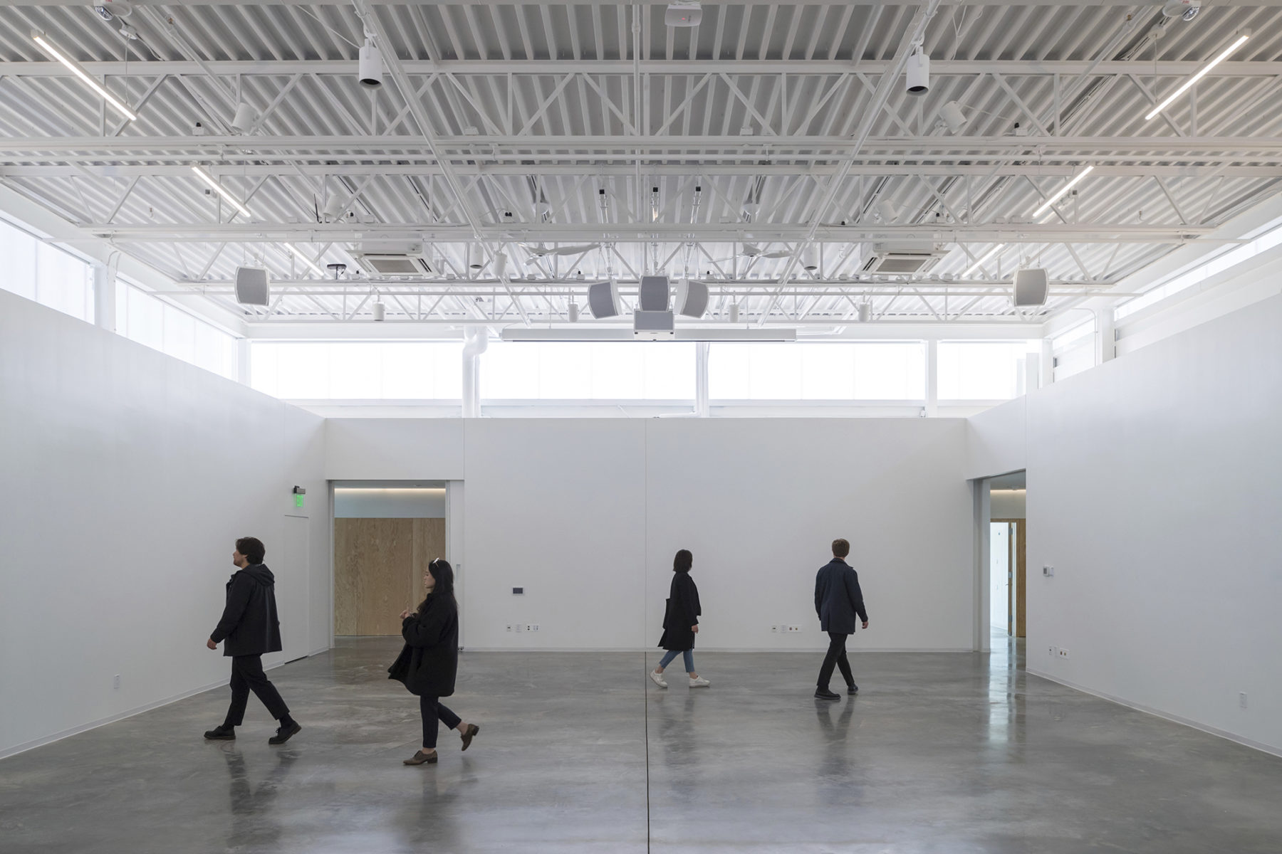 Inside visitors walk around one of the building's galleries