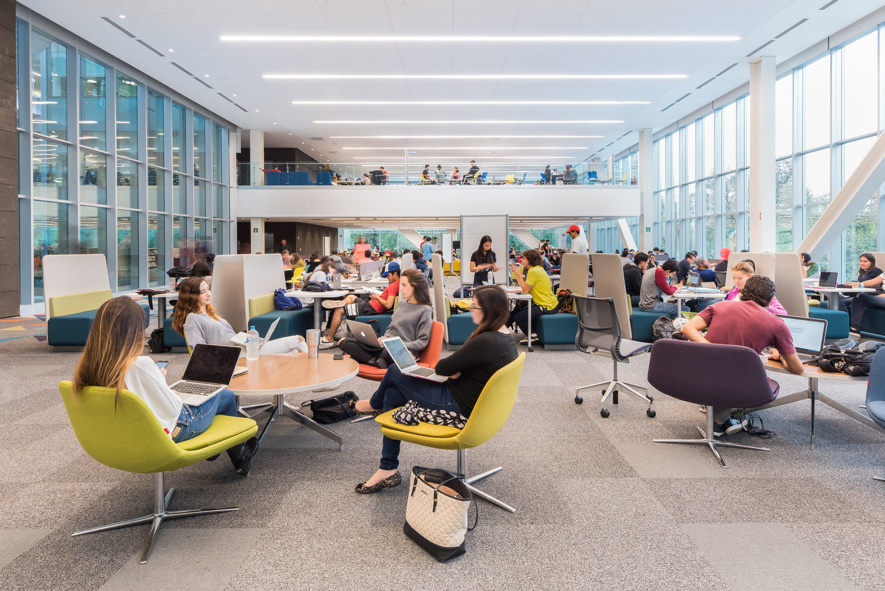 students sit at coworking tables