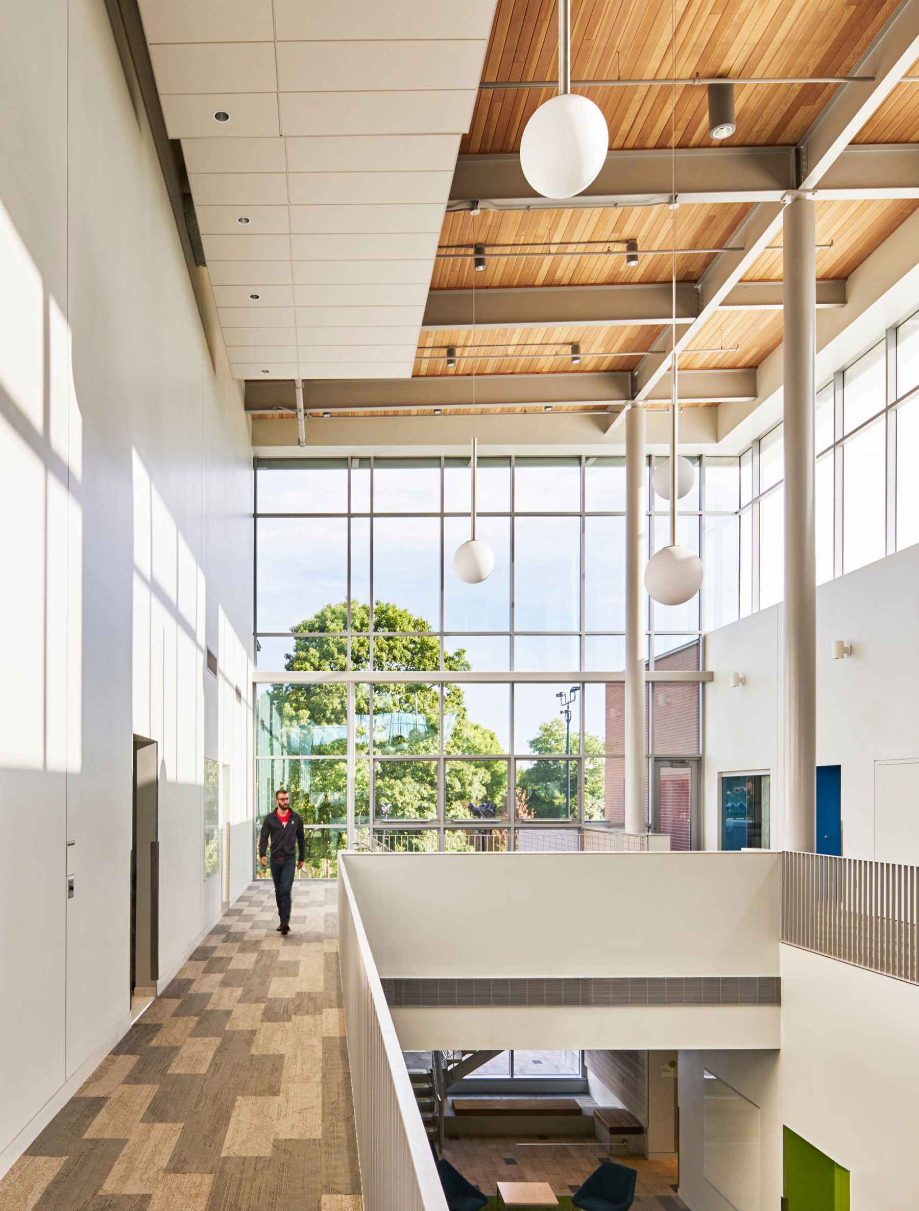 Interior image with open windows and person walking