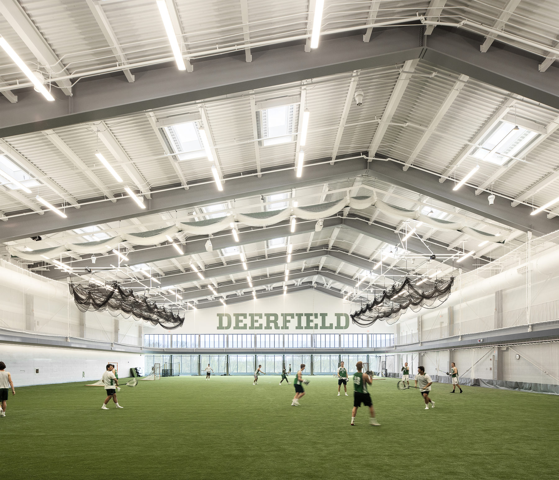 inside view of field house, students playing lacrosse