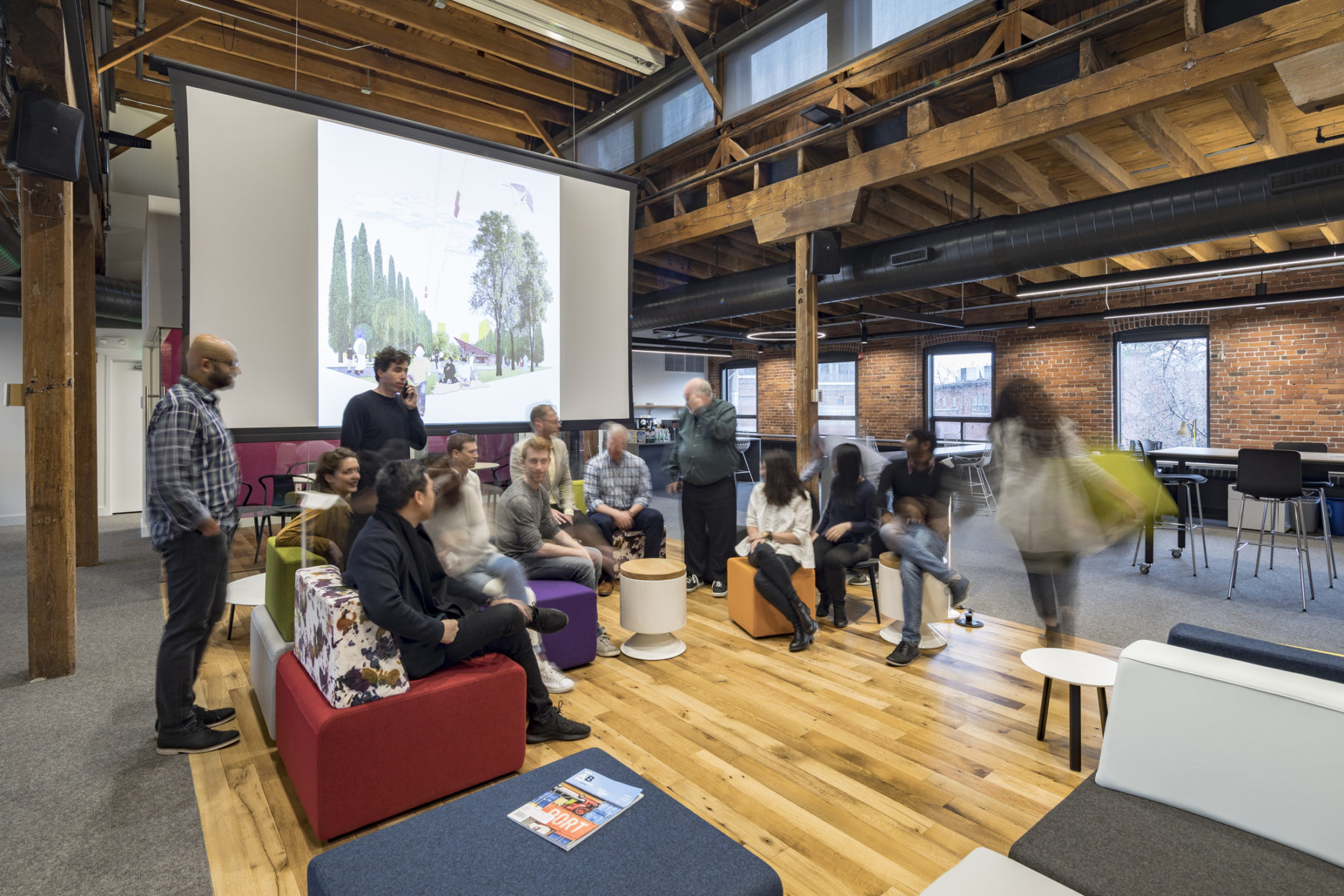 people gathered around a large screen