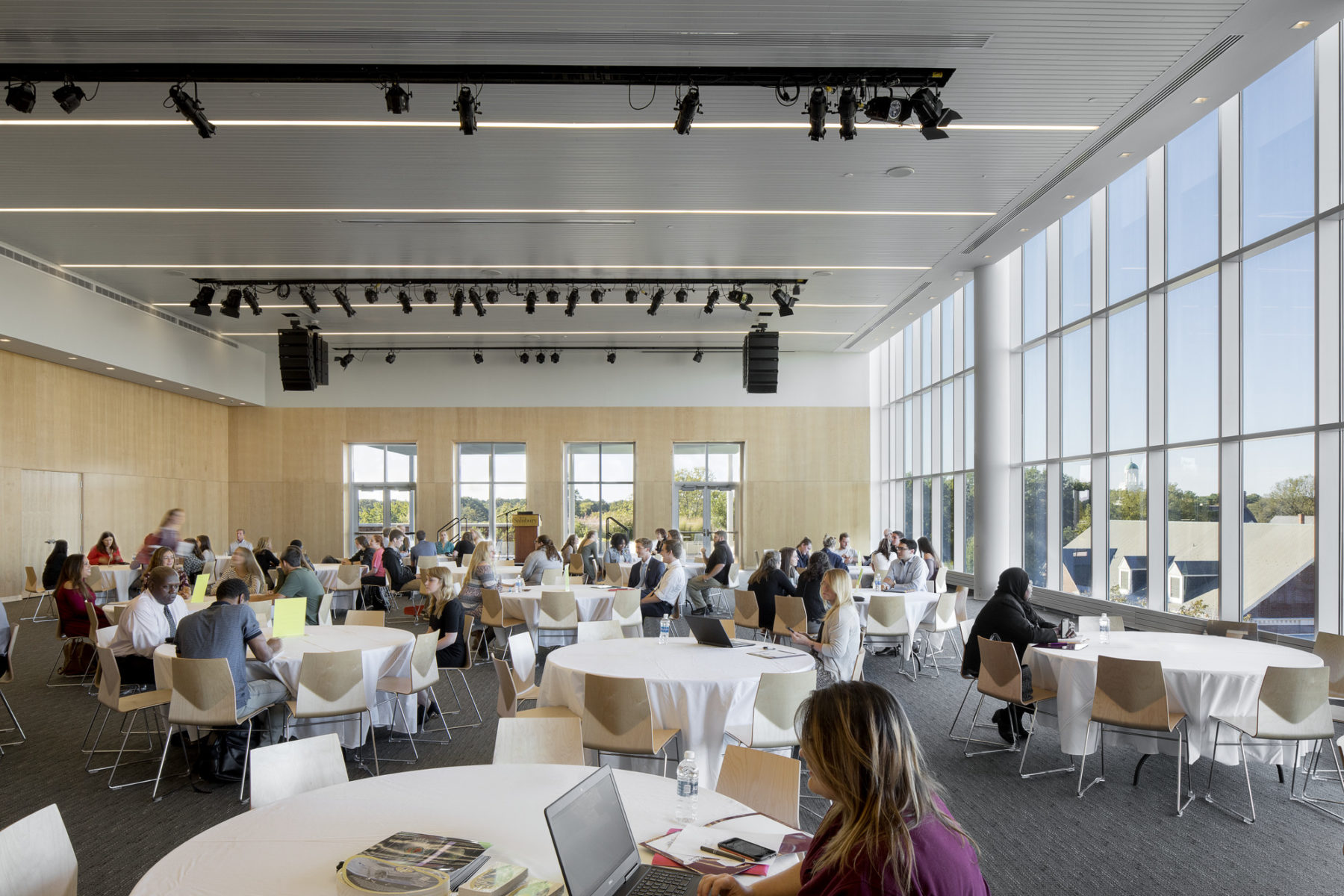 people at tables in an event space