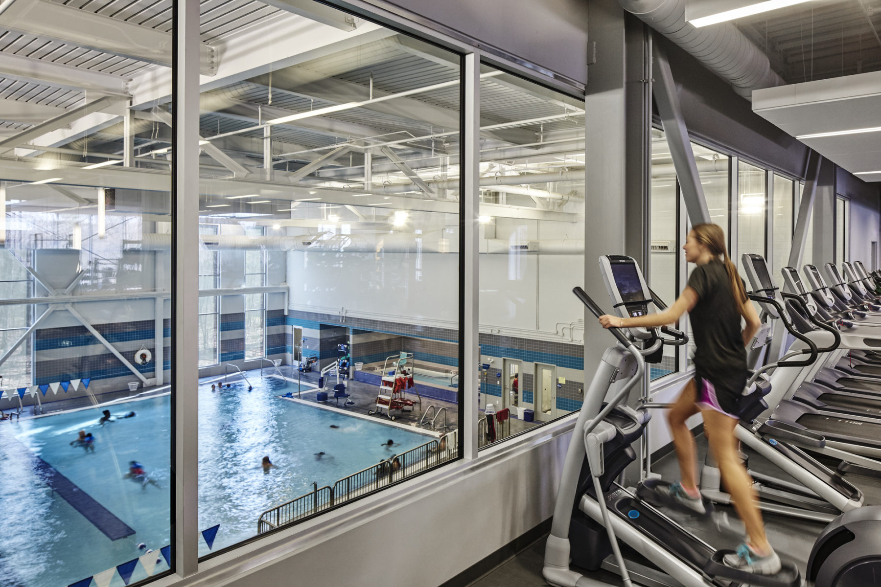 someone on elliptical overlooking a pool