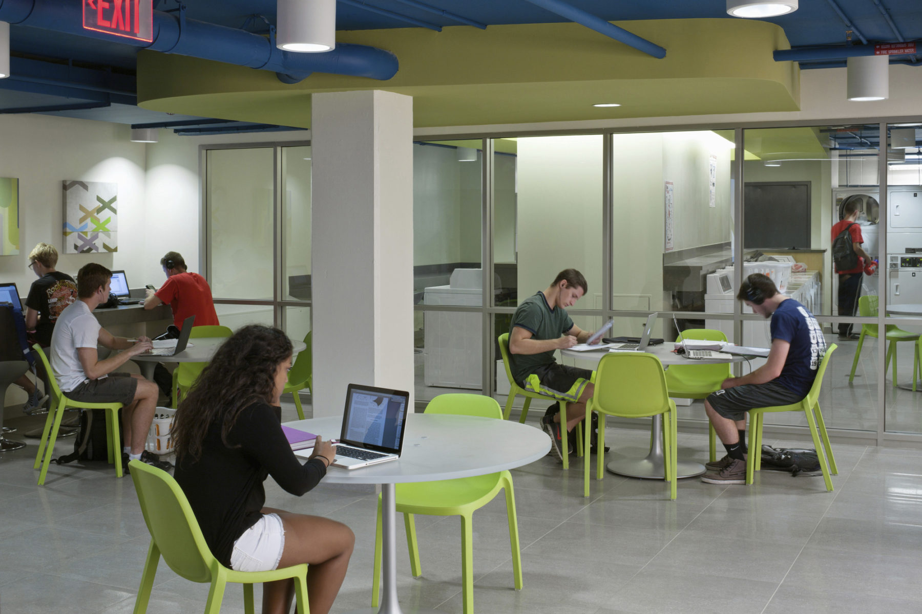 students at tables in common area