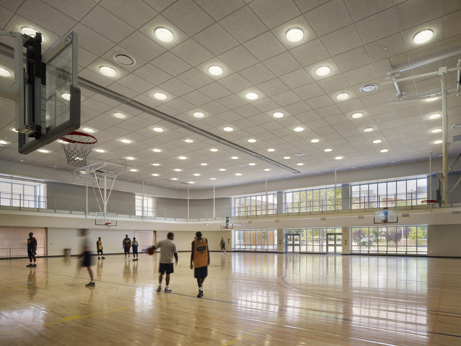people playing on an indoor basketball court