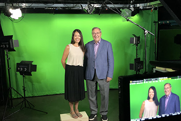 Ocampo and Gary Hack in front of a green screen.