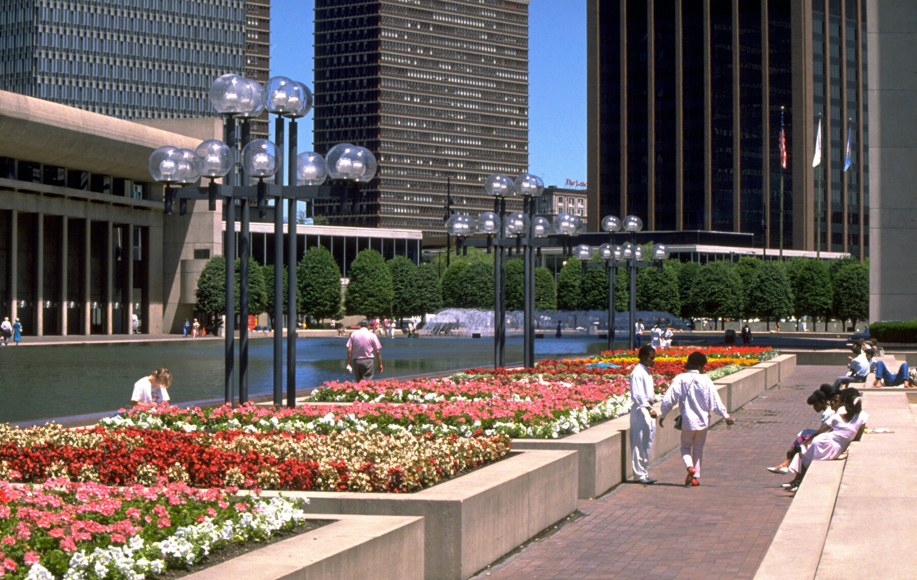 photograph of colorful flower beds bordering reflecting pool