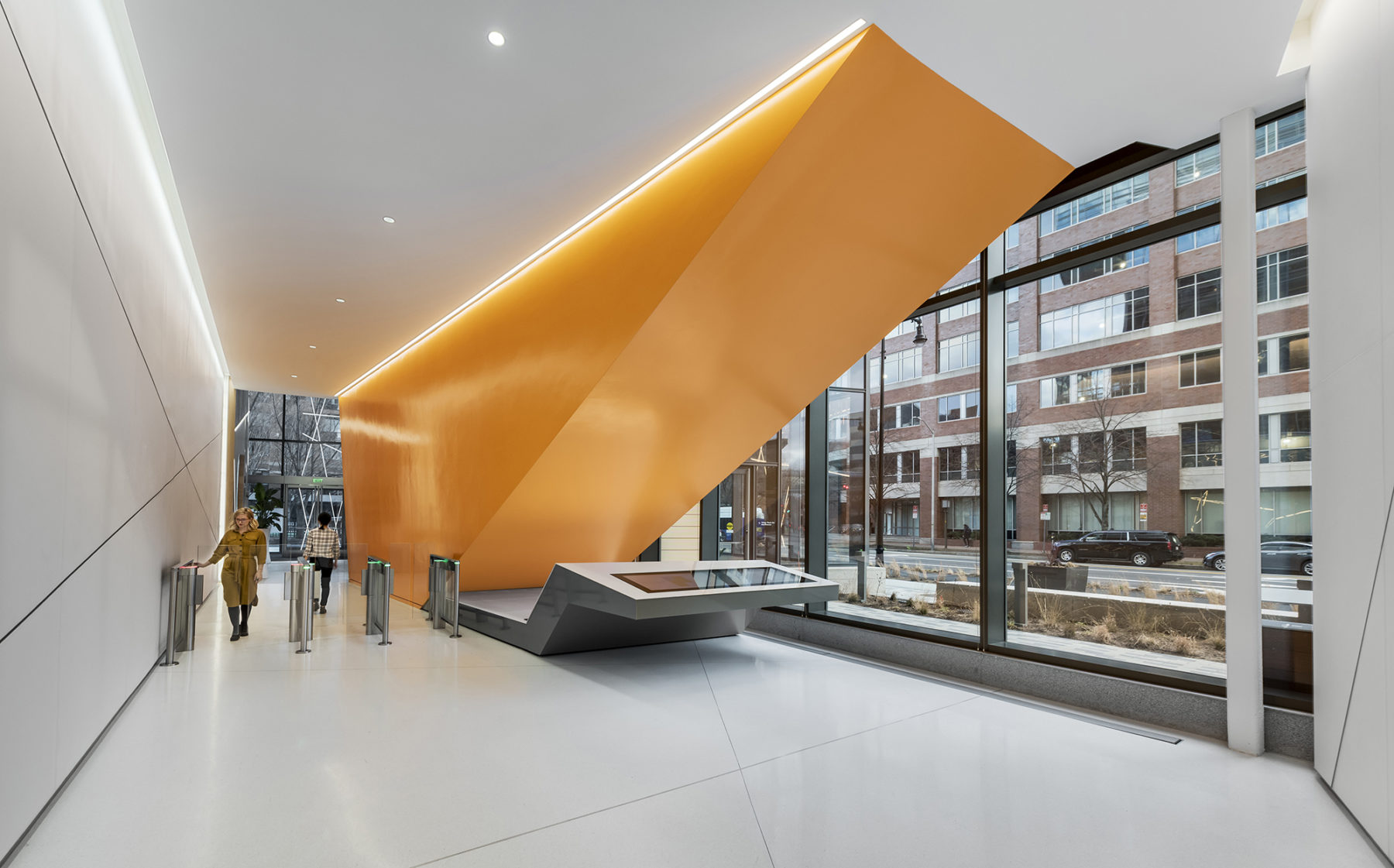 people walk through security gates in the lobby entrance