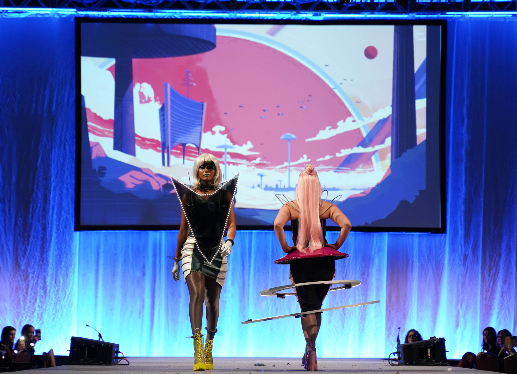 Two models walking down runway