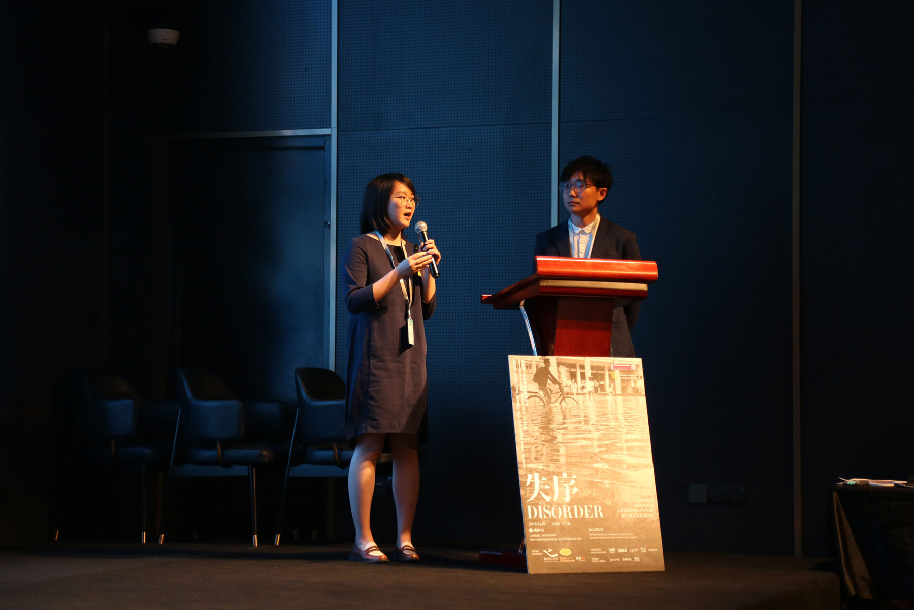 two people speaking at a podium