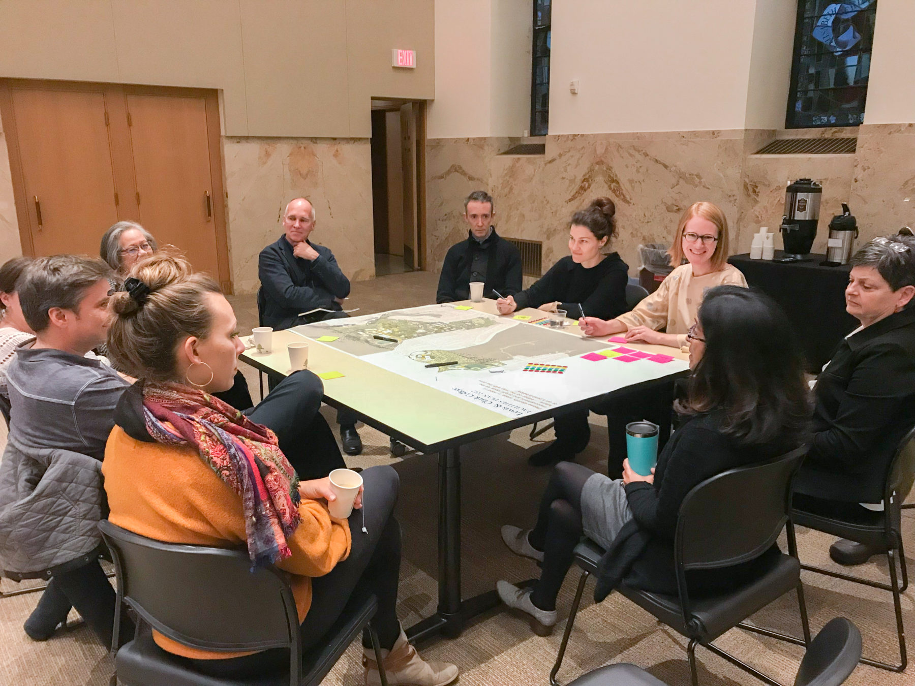 Group of people having a discussion at at a table