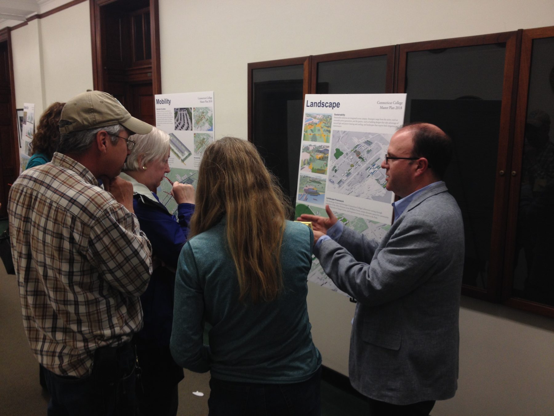 People engaging with a poster board