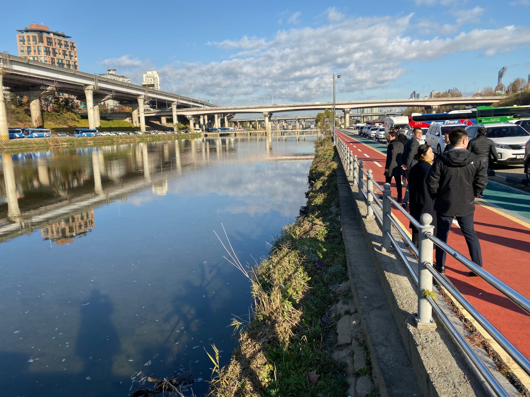 People standing along waterfront