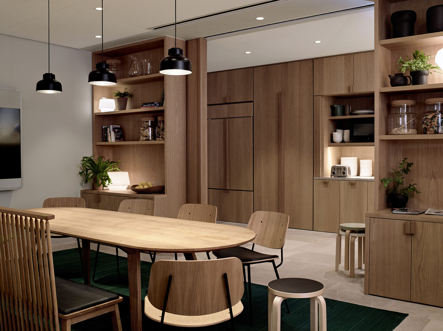 kitchen area with common table and wood cabinetry