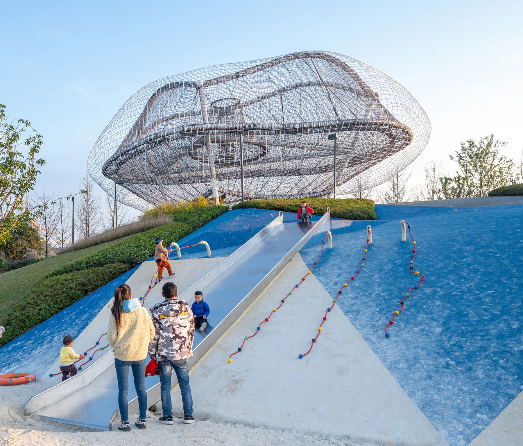 family playing on slide near cloud