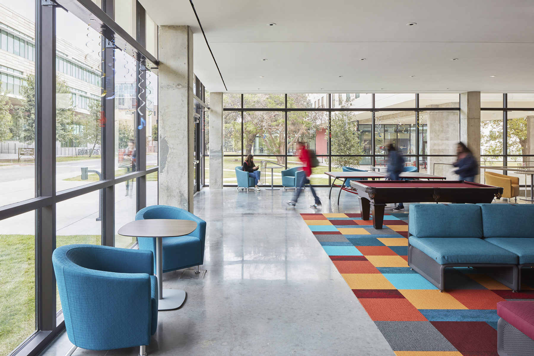 colorful lobby lounge space, windows surrounding