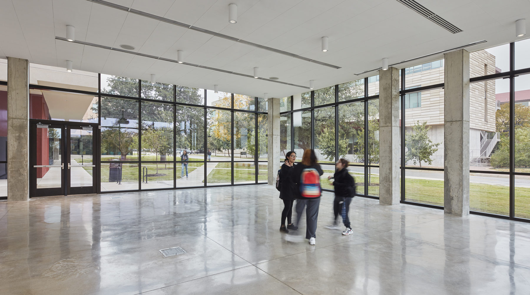 interior large multi-function space, students in the middle, surrounded by windows