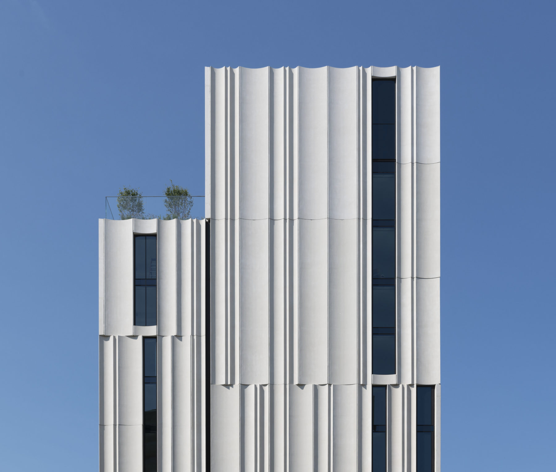 exterior elevational photo of top of building against a pure blue sky