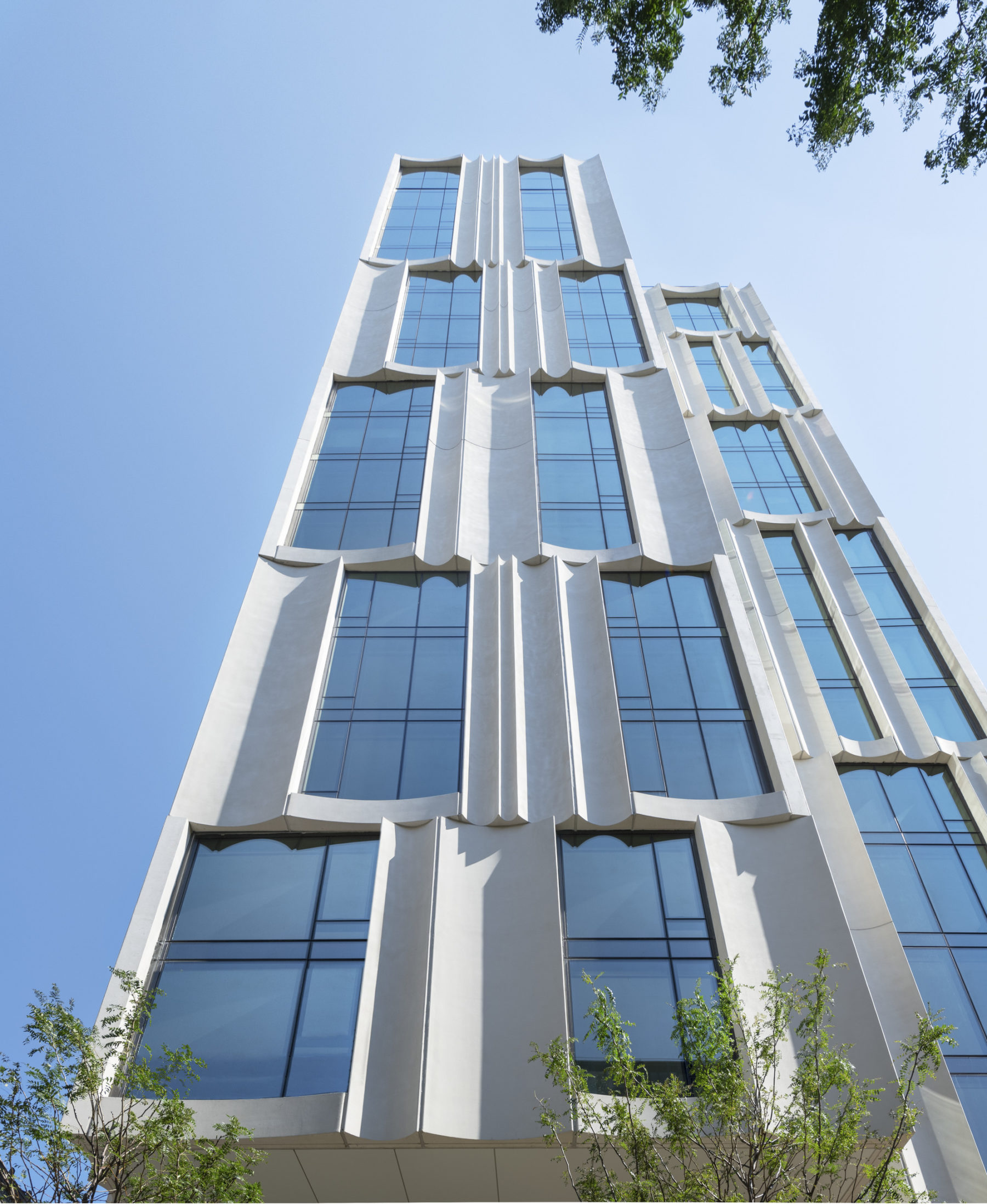 photo of building exterior from ground looking up at the narrow side of the building