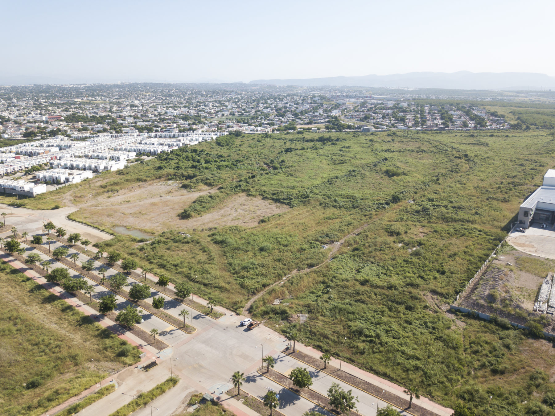aerial view of large grassy expanse surrounded by minimal development