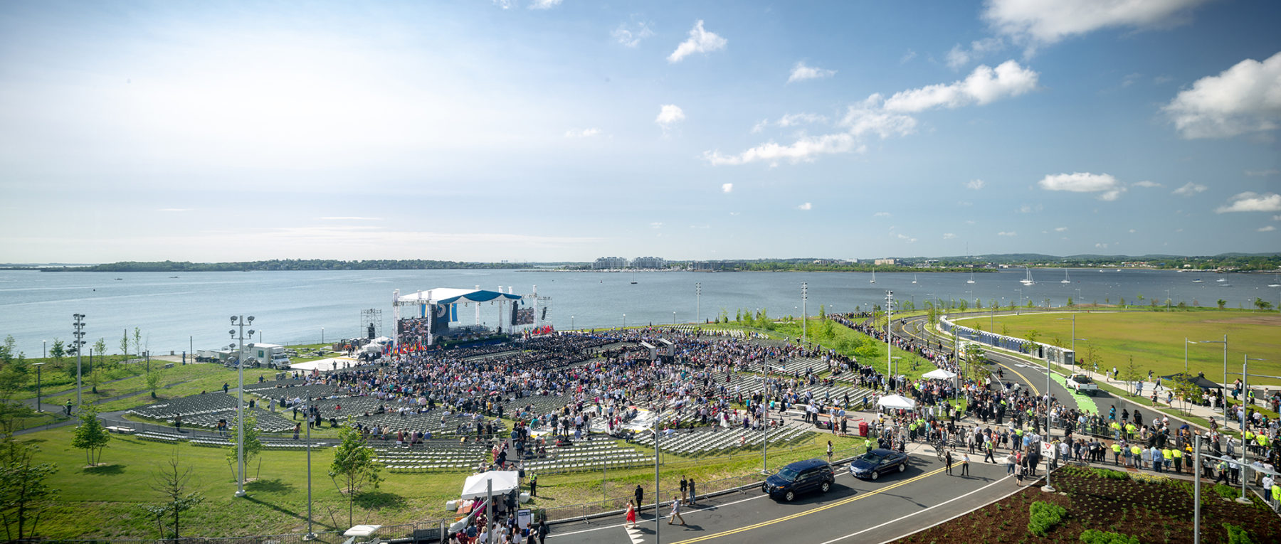 photo of crowd on lawn near waterfront