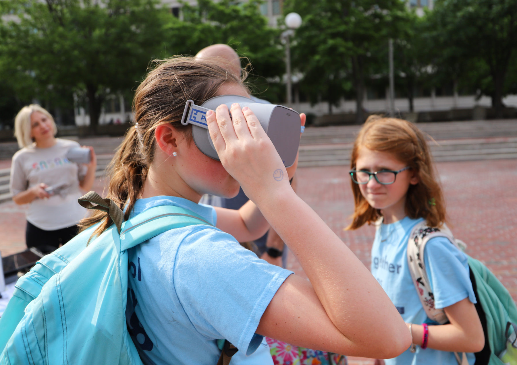 Young girl looking through VR goggles