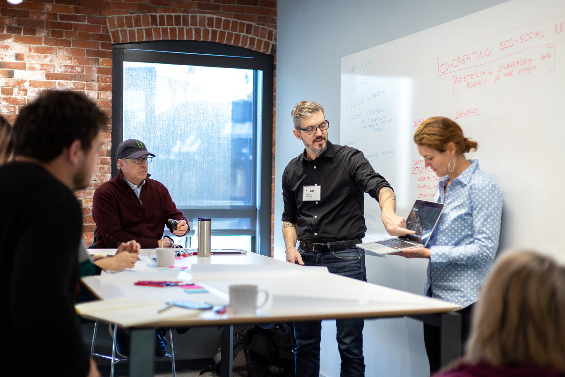 two people presenting to a group of people