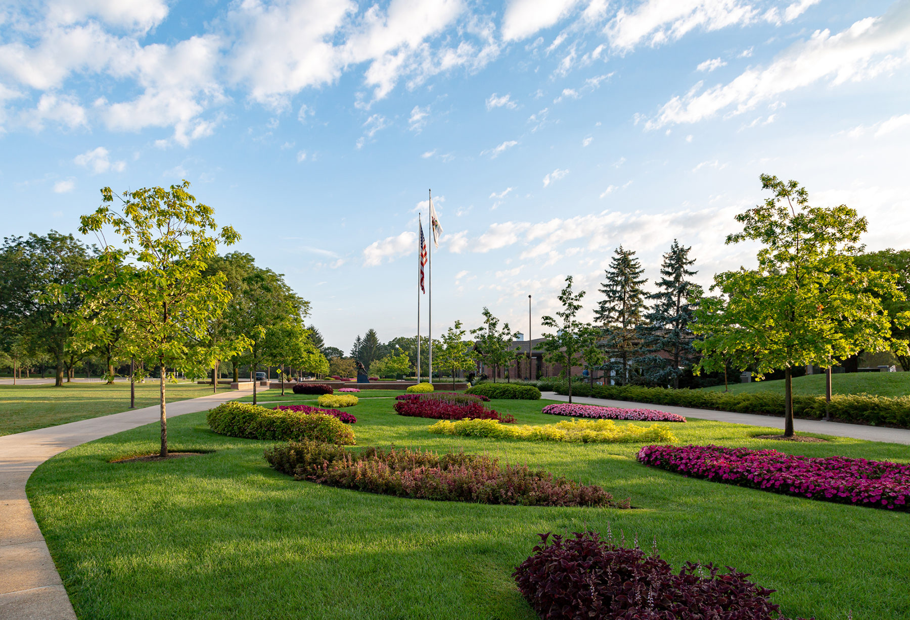 photo of large landscape with flagpoles in the background