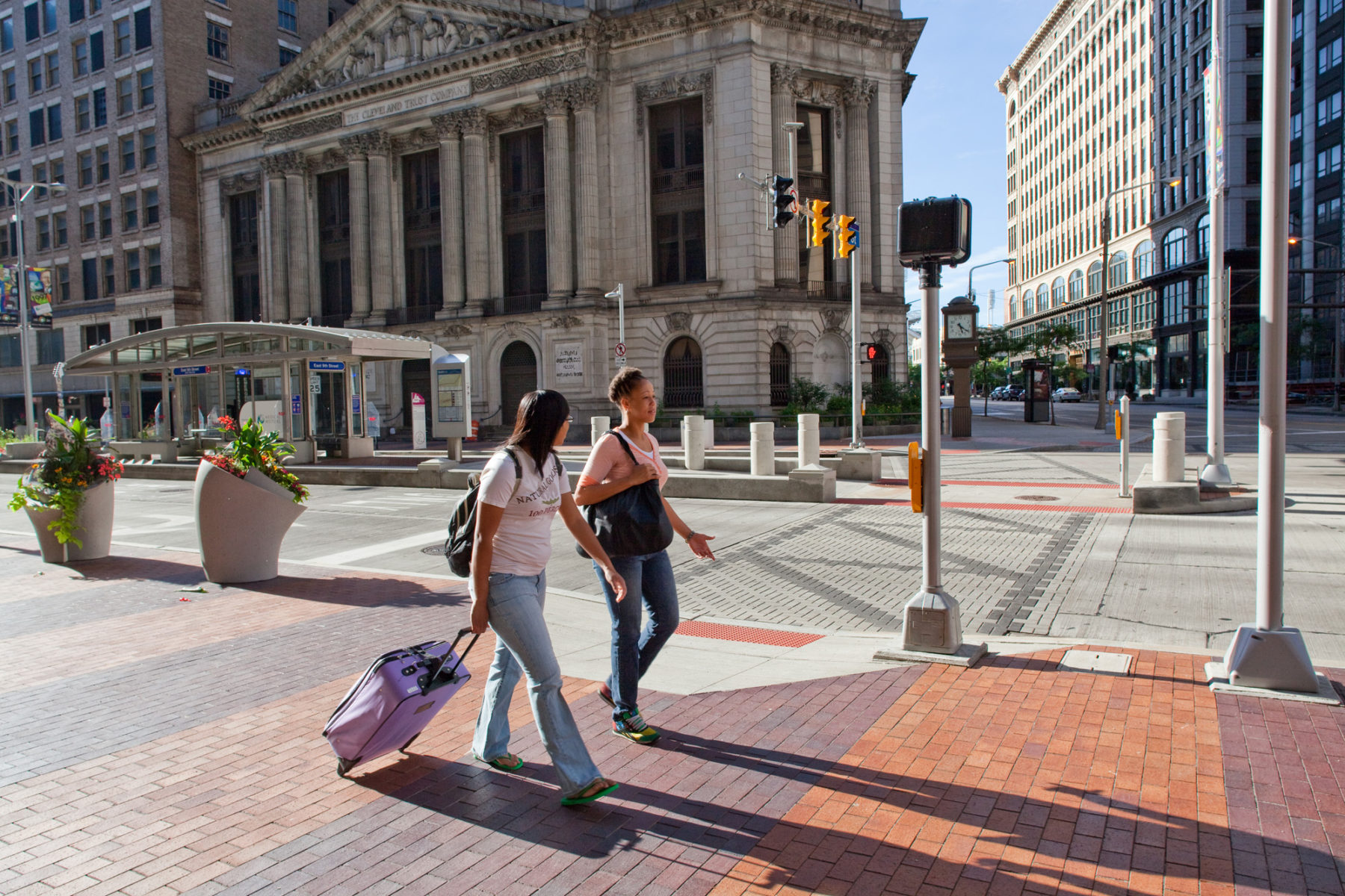 daytime photo of people walking street corridor