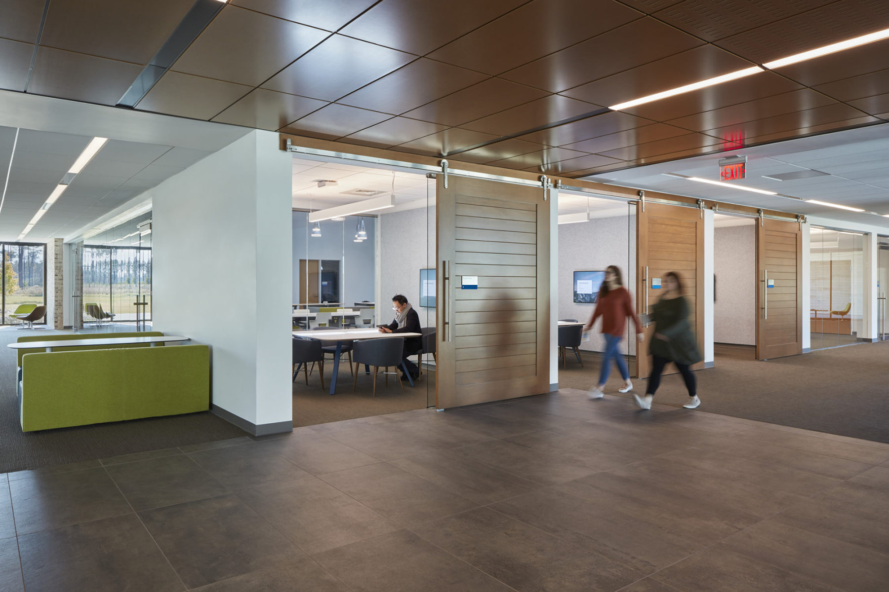 corridor with sliding barn doors for small meeting rooms