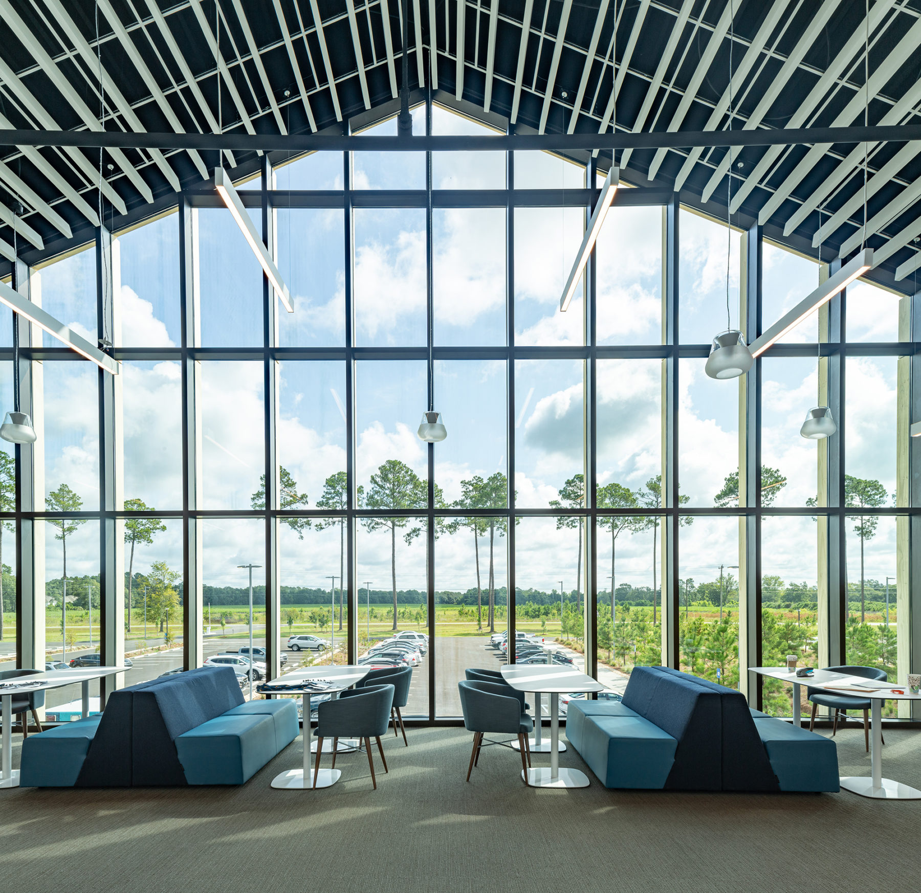 view inside looking out floor to ceiling windows, out onto the surrounding landscape