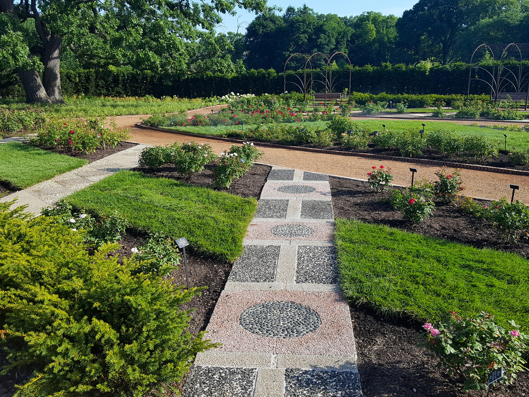 a mosaic path through a garden