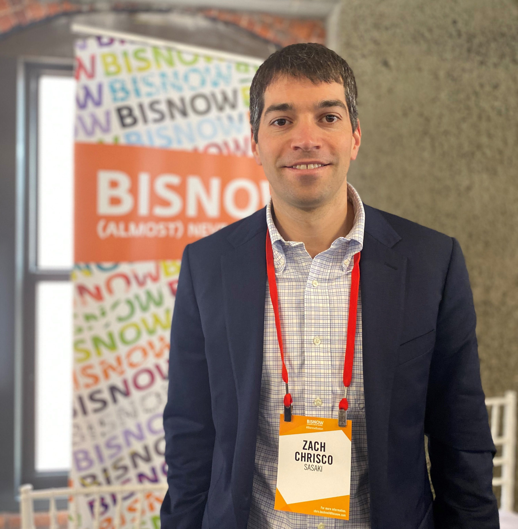 zachary chrisco standing at bisnow panel