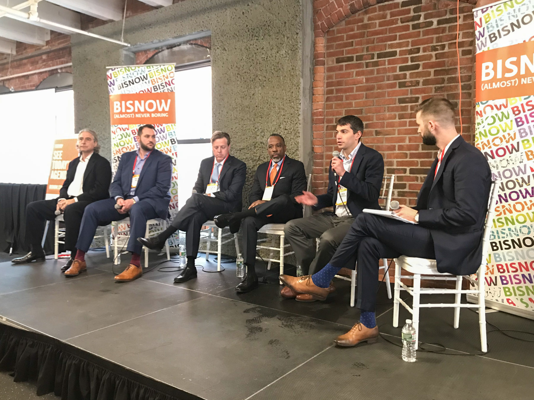 A group of men sitting for a panel discussion