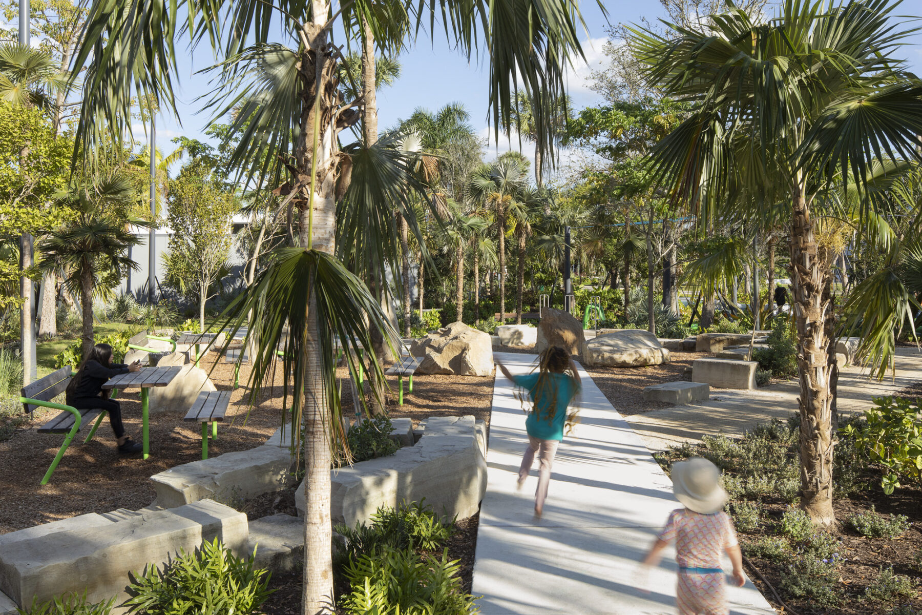 perspective shot of children running on playground path