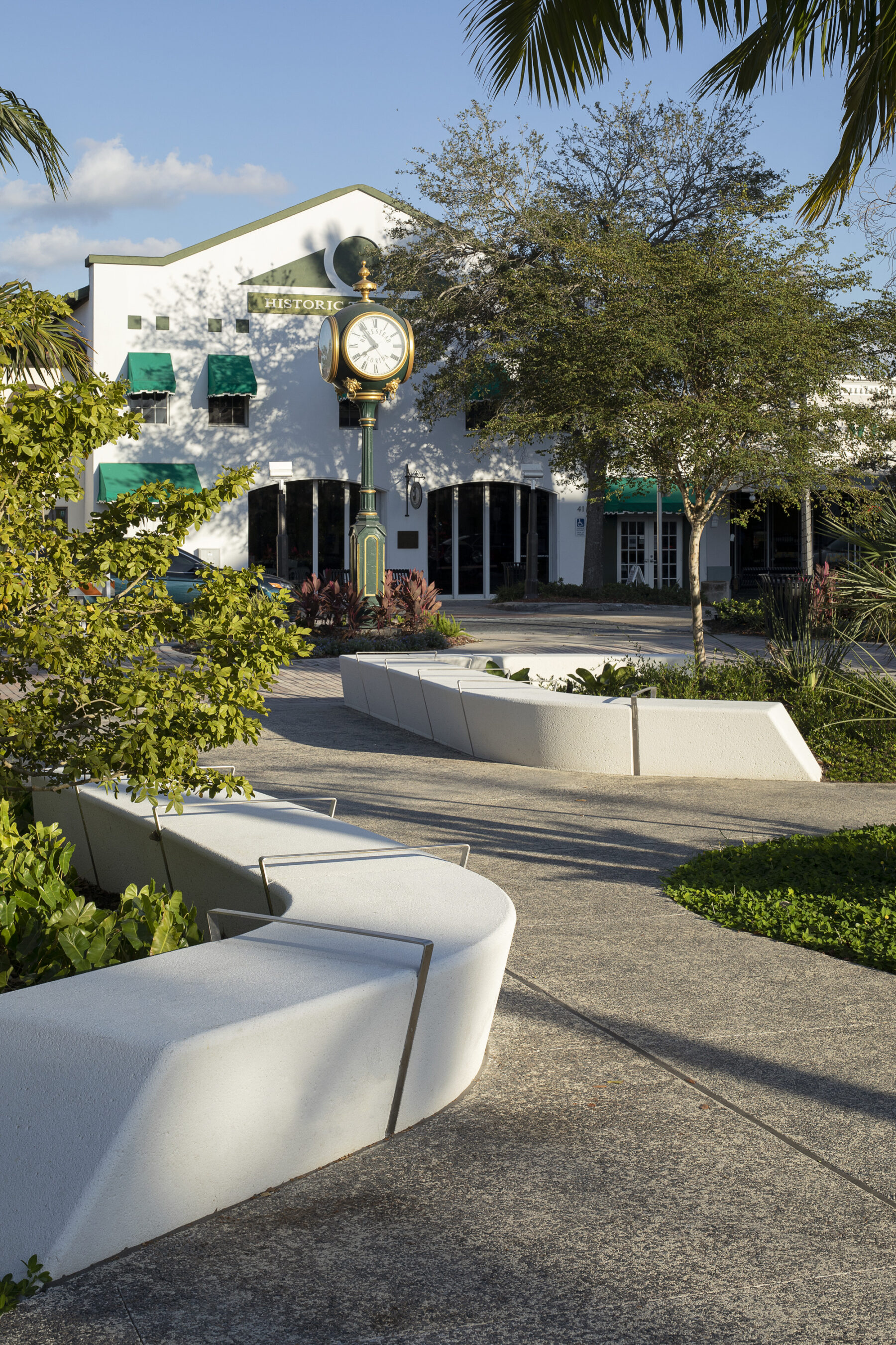 perspective photograph of losner park benches with park clock tower in background