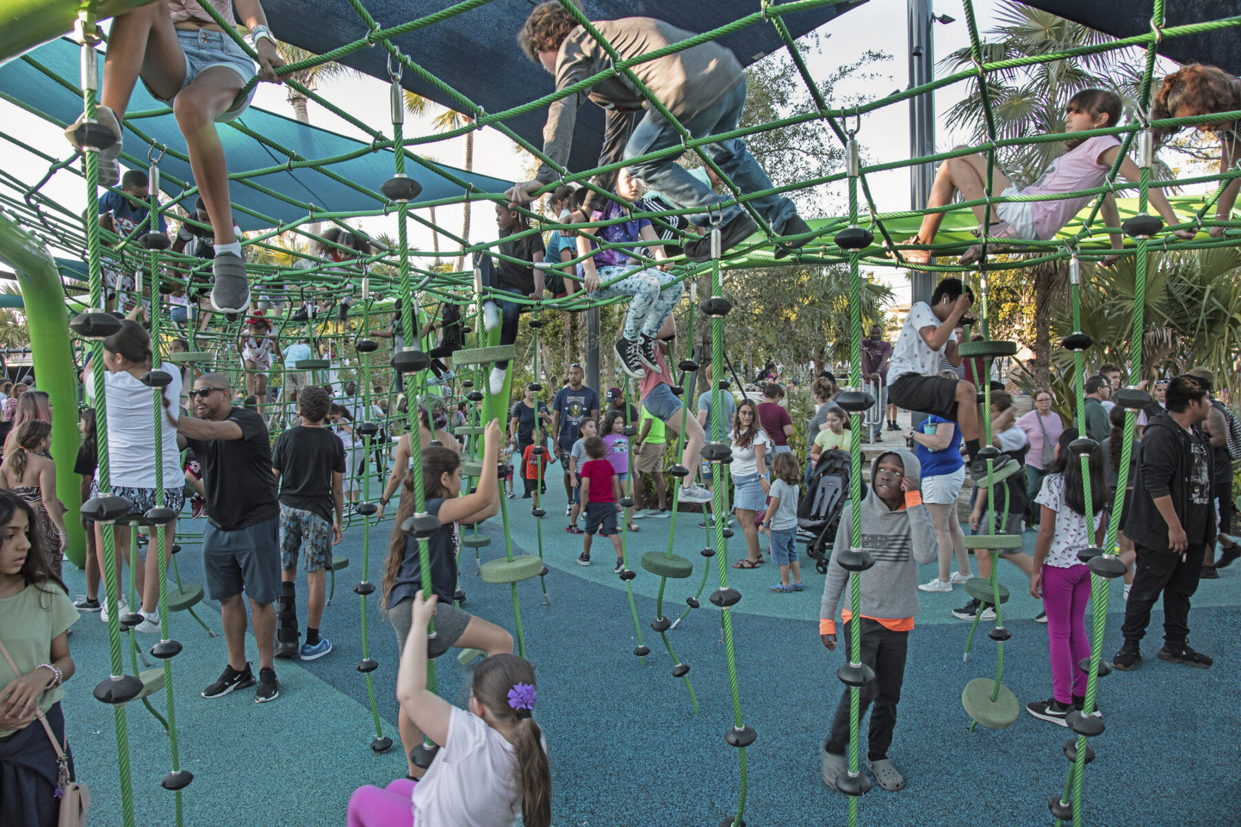 photograph of children playing on vertical rope course