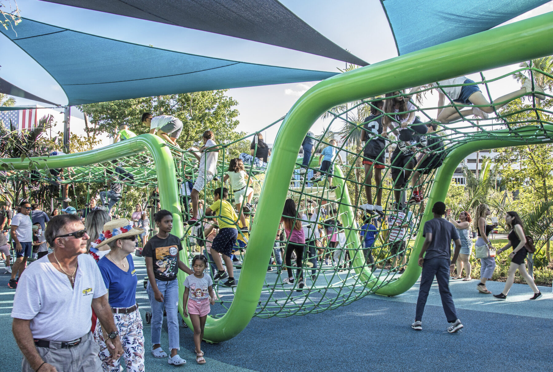 children playing on bright green sculptural play space