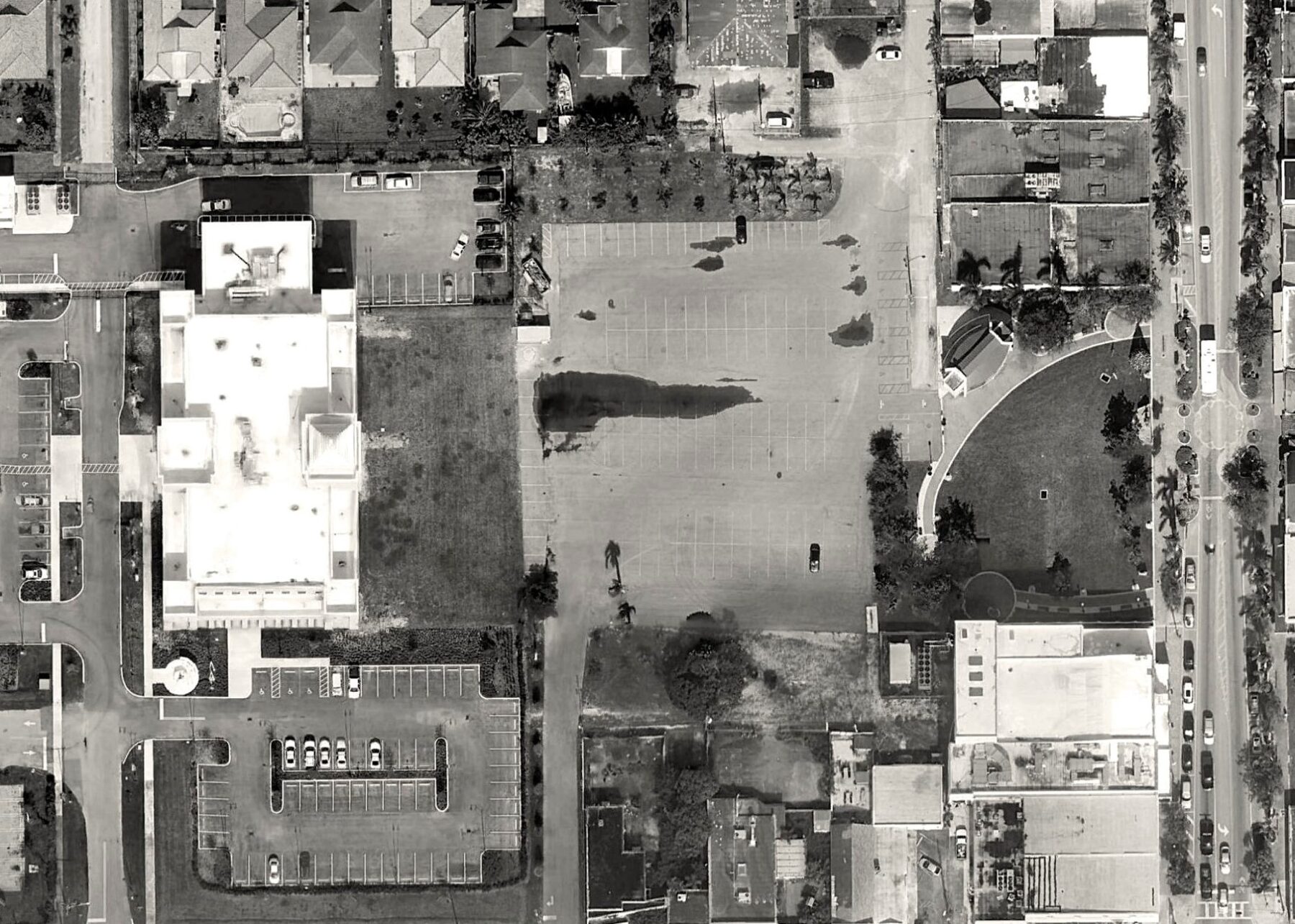black and white aerial photograph of losner park's existing conditions featuring a small lawn and paved lot