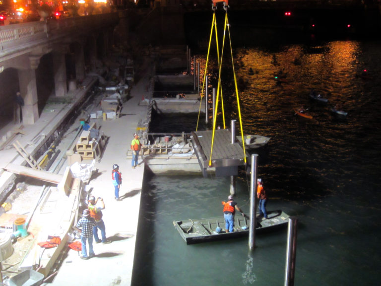 a photo of a construction site on a river at night