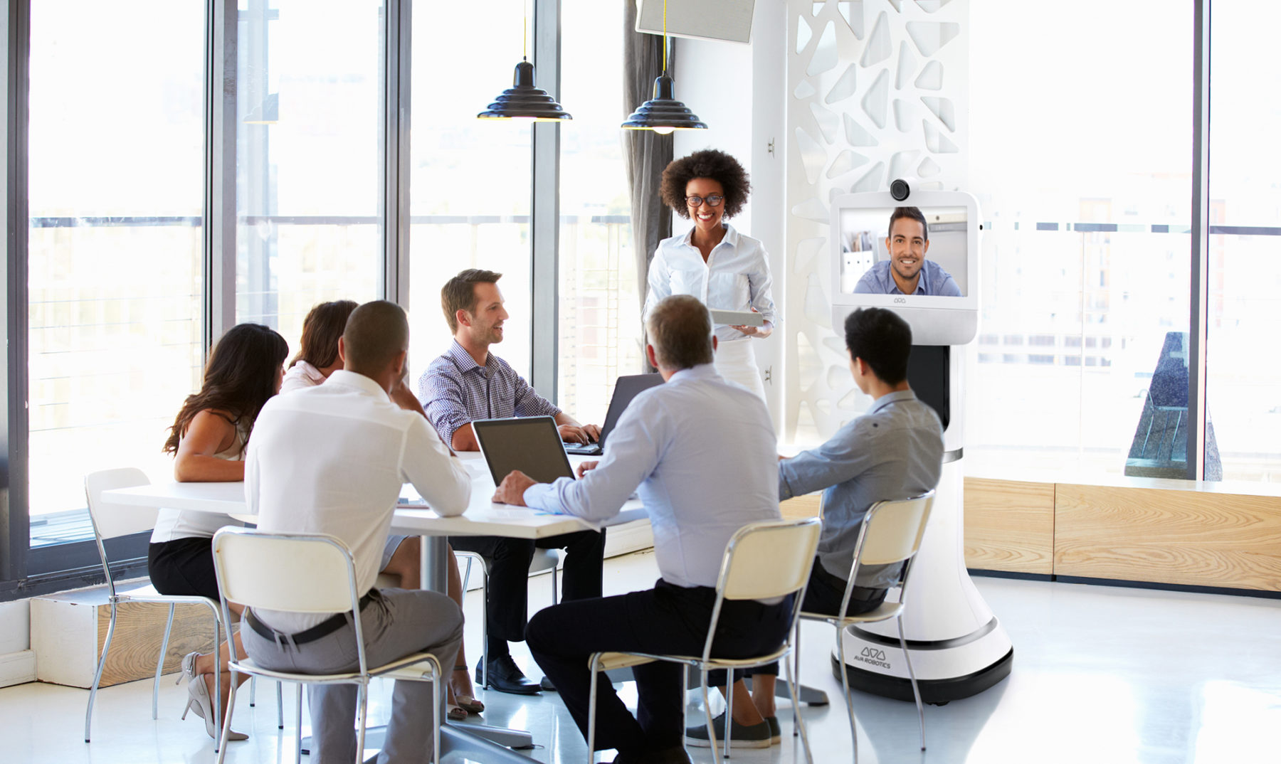 AVA stock image of meeting happening with AI robot