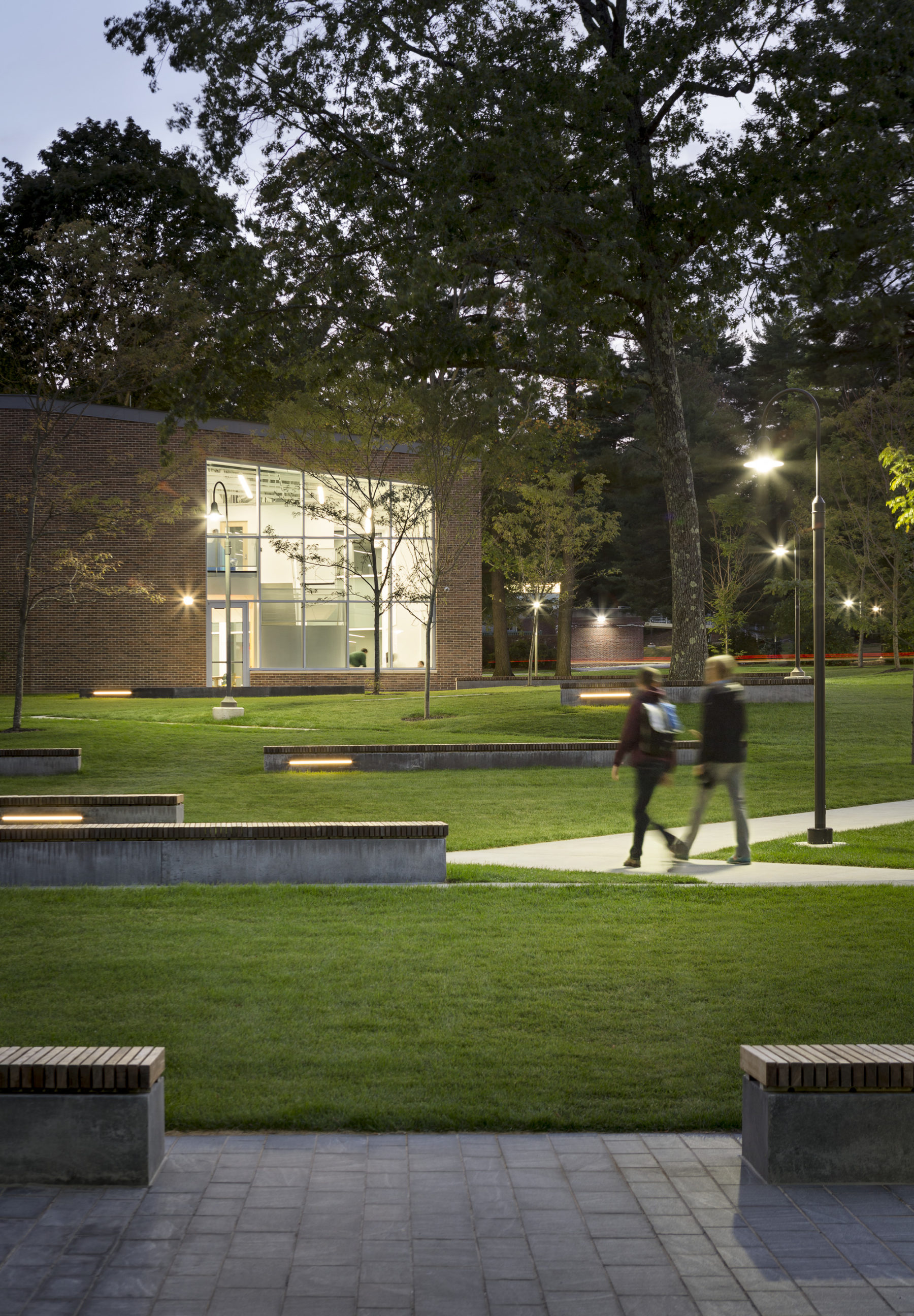 students walk paths at night