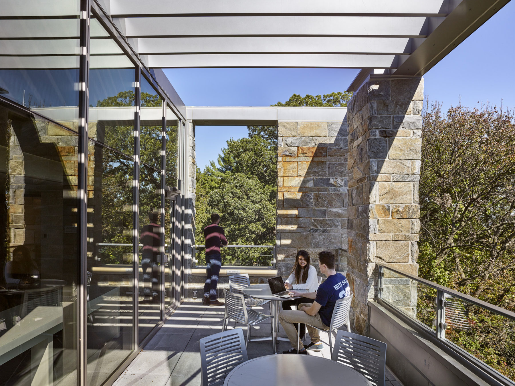 Students sit on outdoor terrace