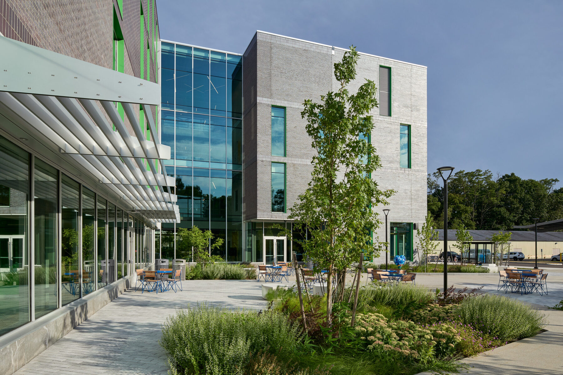 Exterior view of facade with four story curtainwall at the central nexus overlooking the terrace