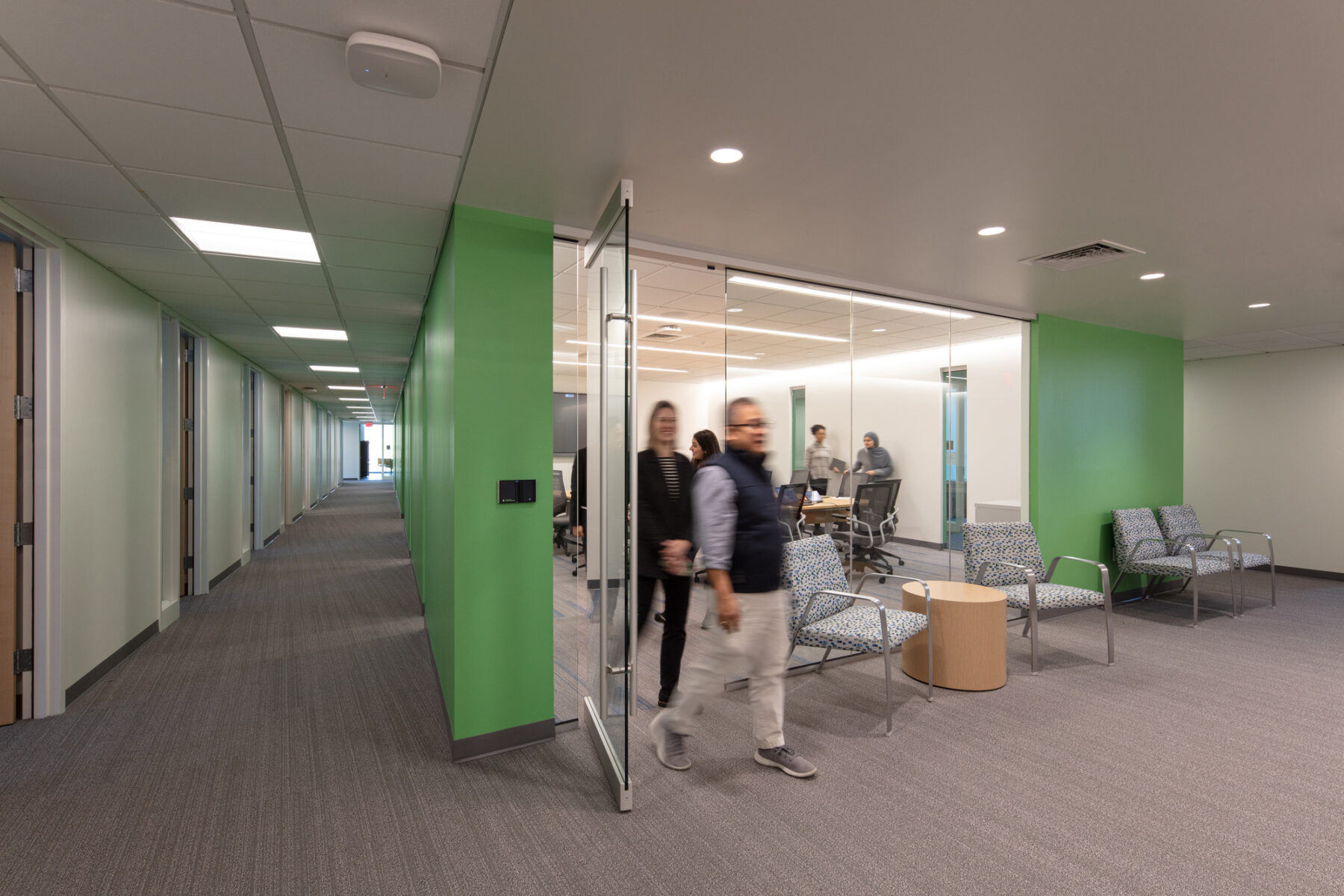 photograph of visitors exiting classroom adjacent to lab corridor